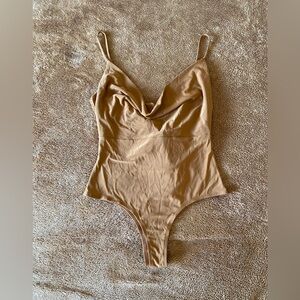 Tan draped neck bodysuit in size medium